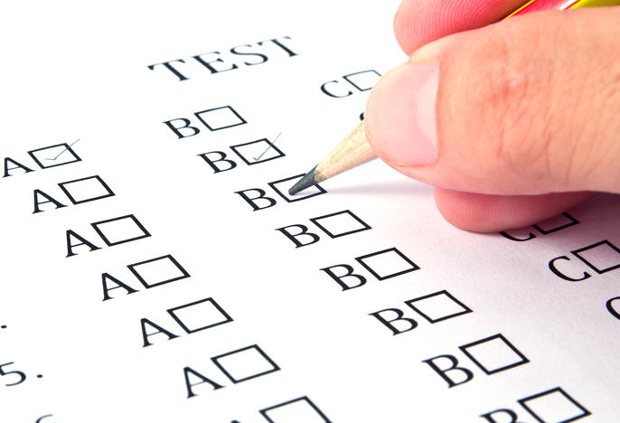 Student checks a box on a multiple choice test form.