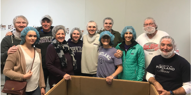 Boise Alumni in their hairnets volunteering at a local food bank.