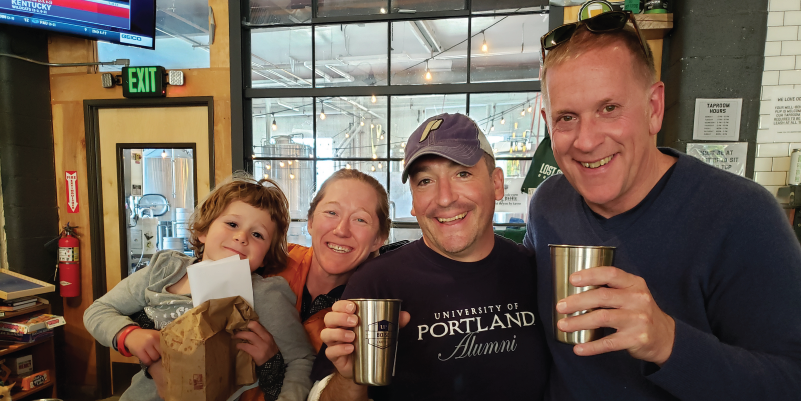 Four UP alumni enjoying a brewery with UP stainless steel cups