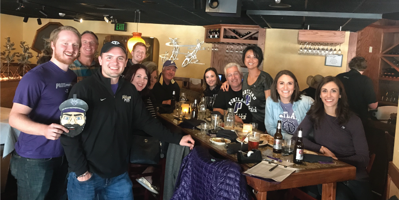 UP alumni sitting around a table at a brewery.