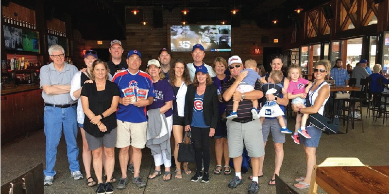 UP Alumni standing at a Chicago Cubs baseball game.