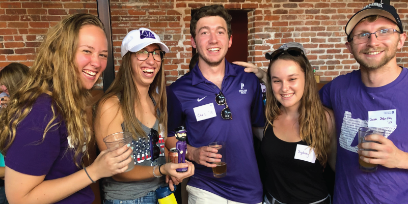 Some young alumni enjoy a beer at a Rockies game