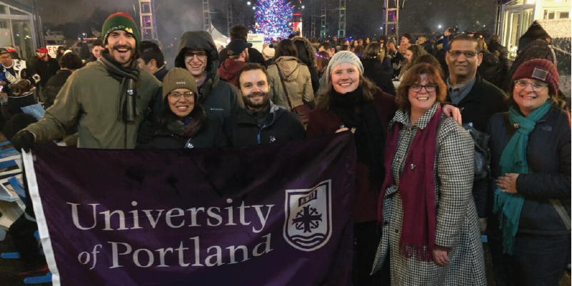 Alumni holding a UP flag at the parade of lights.