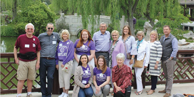 Alumni posing in a Japanese garden.