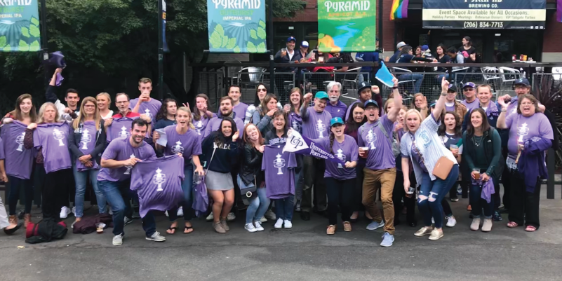 Alumni in front of Pyramid Brewing Company before the Mariners game