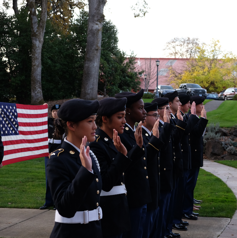 Cadets in a line holding up their right hand
