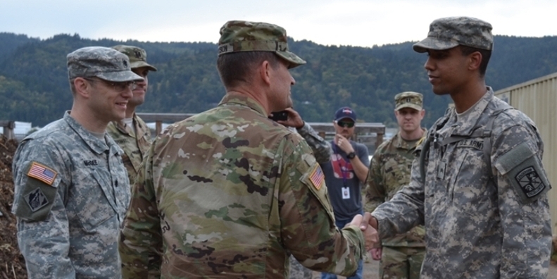 Major General Jackson shaking hands with the color guard sergeant