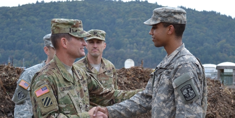 Major General Jackson shaking hands with the color guard sergeant