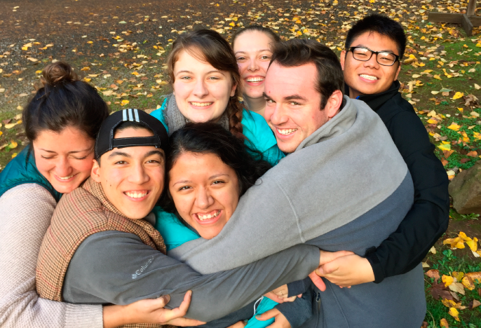 Seven students in a group hug