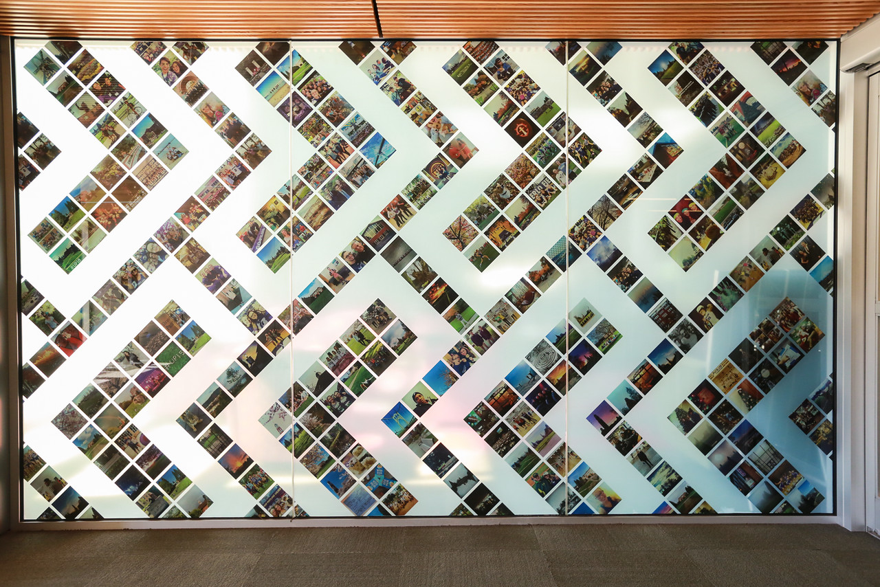 library wall with instagram photos arranged in an arrow design