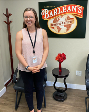 Photo of Katie Moreland in front of the Barlean's logo