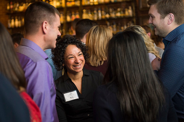 Group of four people talking at a networking event