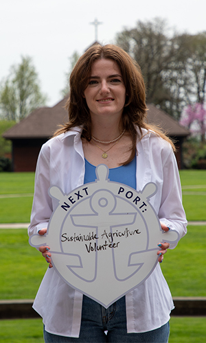 Sarah Tingleff posing with First Port sign