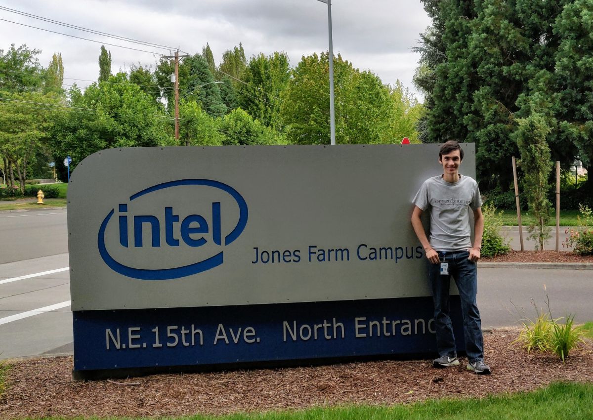 Alex Schendel in front of Intel company sign
