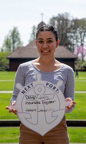 Thelma Mendoza holding First Port sign