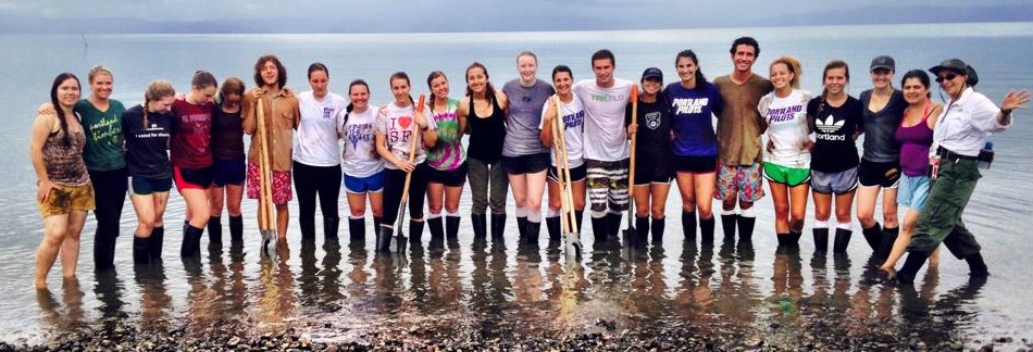 University of Portland Students join Nicaraguan locals in front of a school.