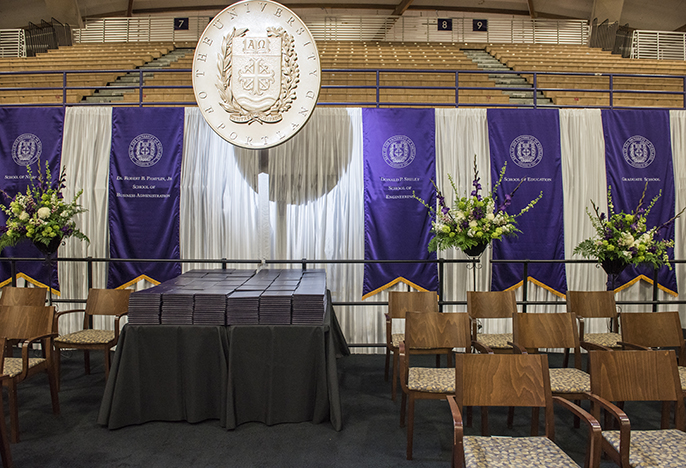 graduation stage set up with large wooden mace