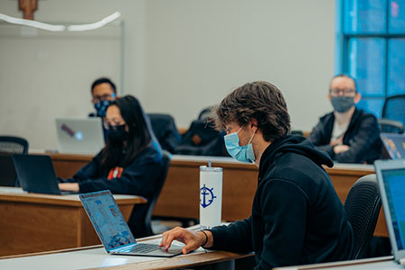 Student on laptop in a classroom