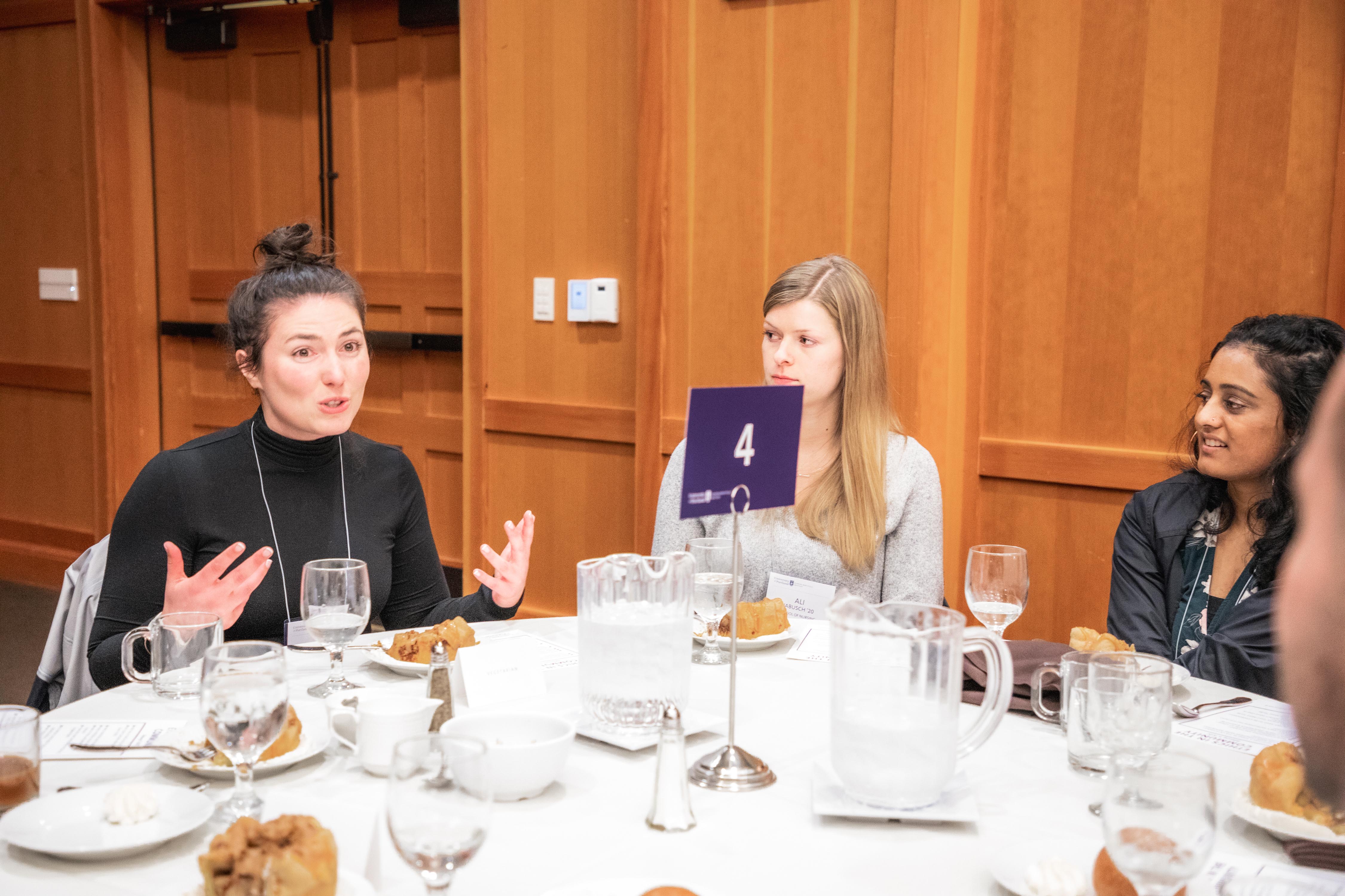 speaker at table with students