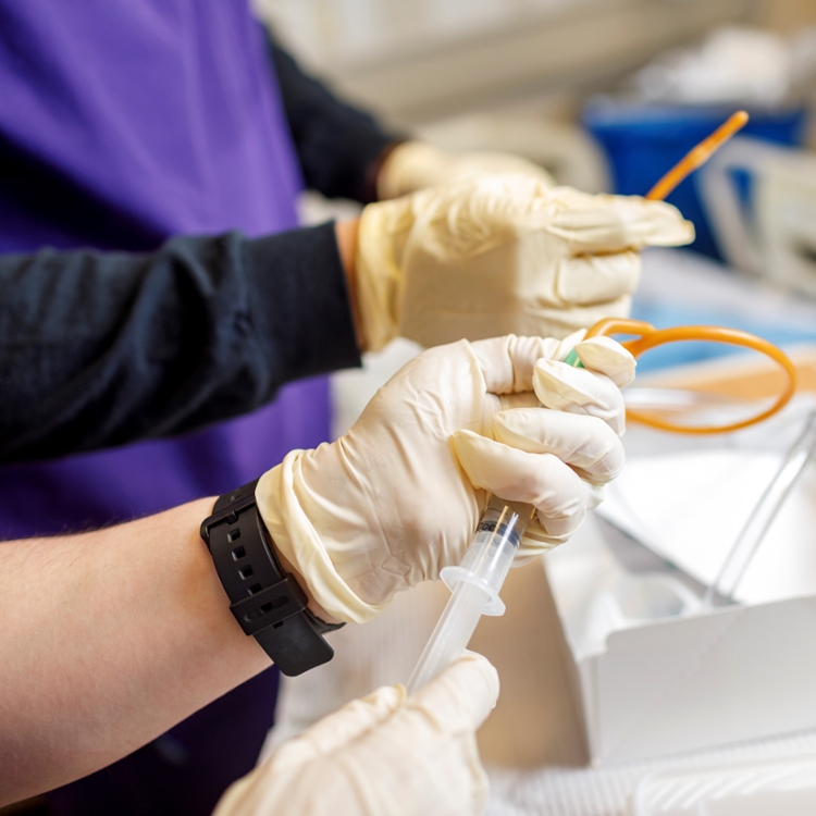 student nurse hands holding catheter.