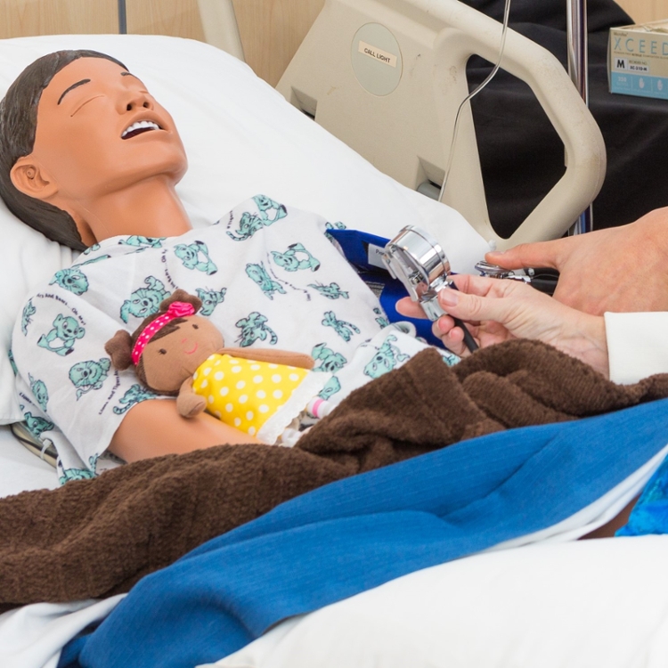 artificial child patient in hospital bed.