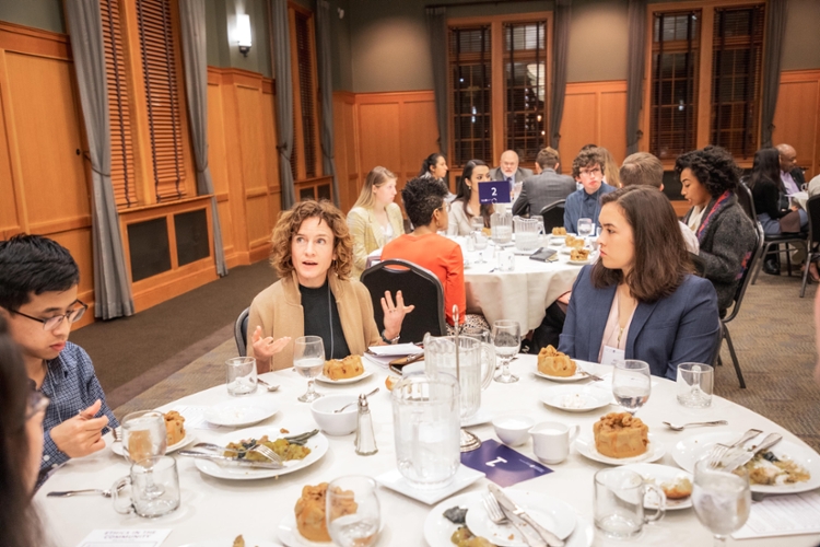 guest speaker talking with students at table