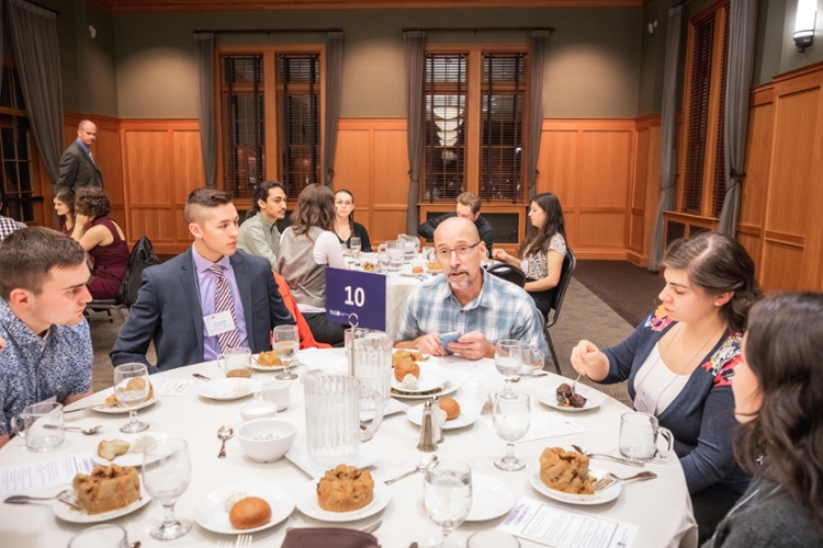 guest speaker talking with students at table