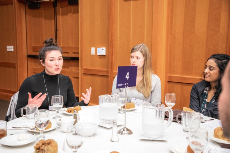 guest speaker talking with students at table