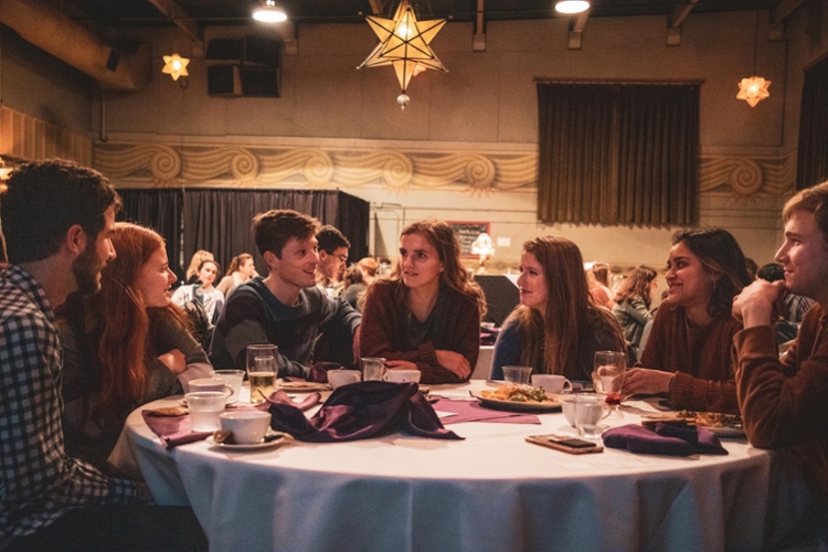 Students talking and sitting at round table