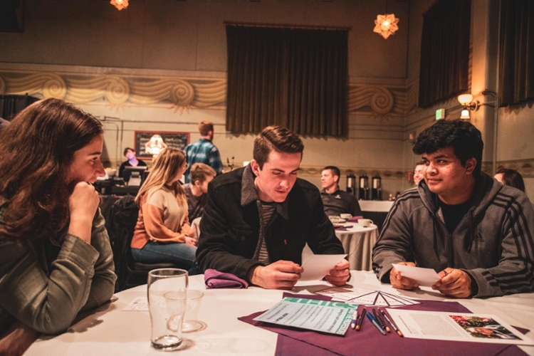 students discussing questions at table