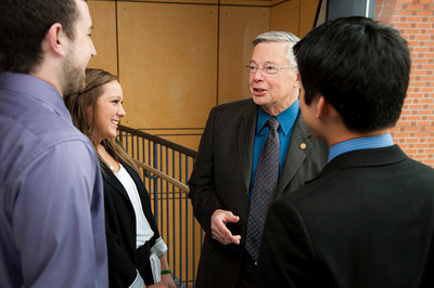 students talking to a professor in the hall