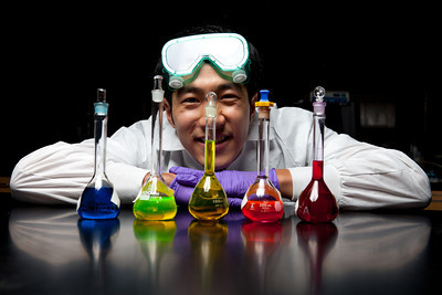 student with science beakers