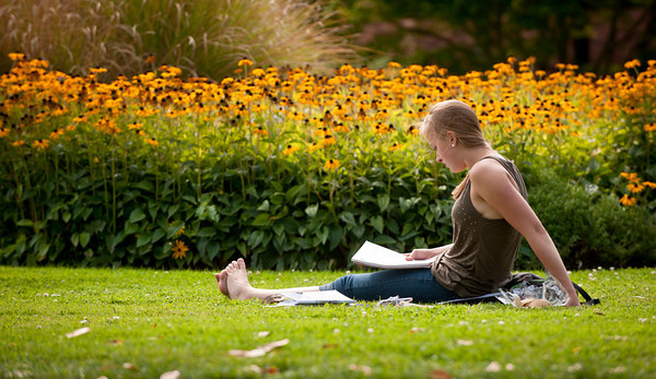 student sitting in grass