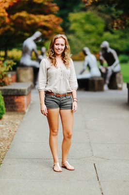 student in front of statues