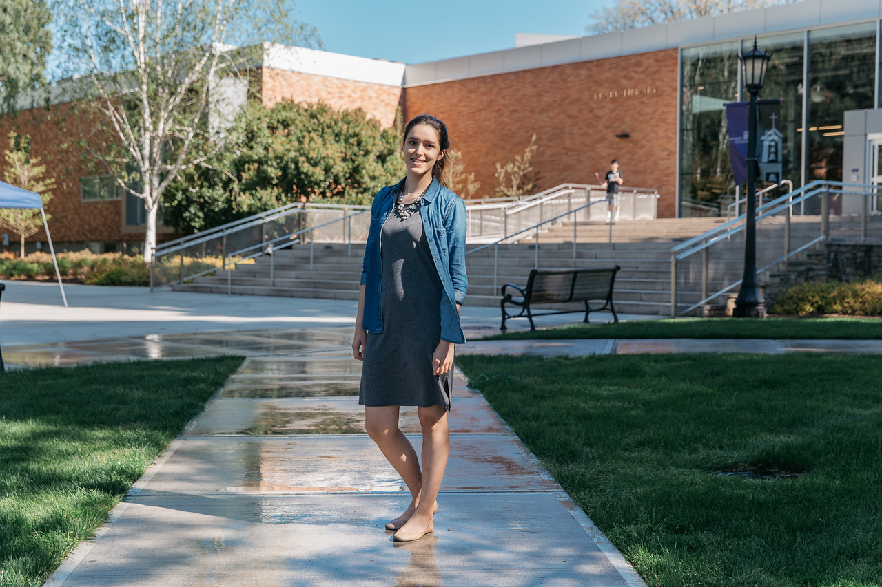 student in front of library