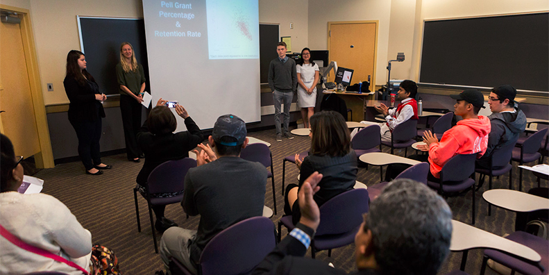 Four students presenting in front of classroom