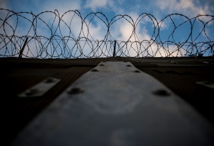 top of U.S. and Mexico border fence with wire