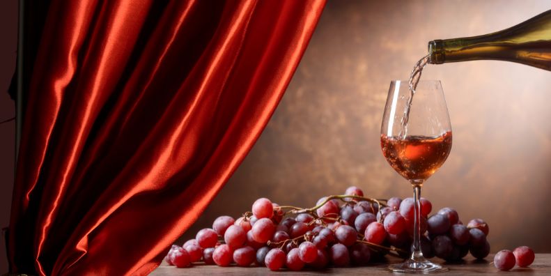 wine, grapes and theater curtain