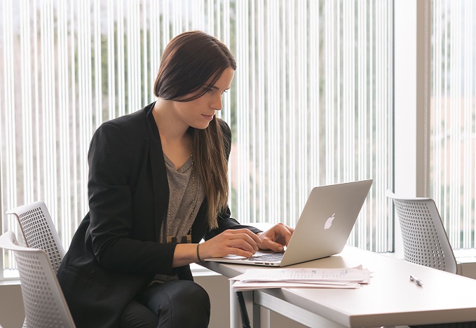 student at desk with laptop
