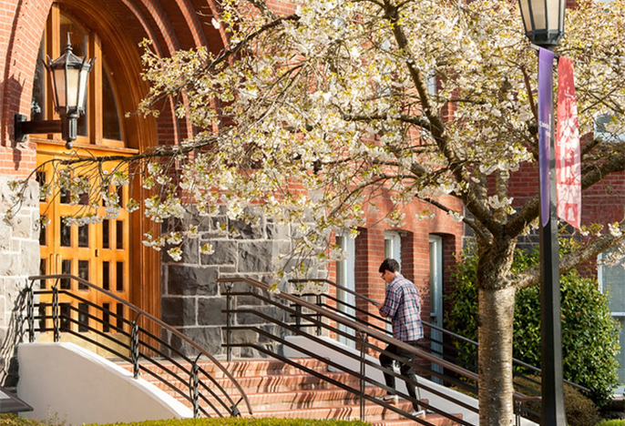 A person walking up the steps of Waldschmidt Hall