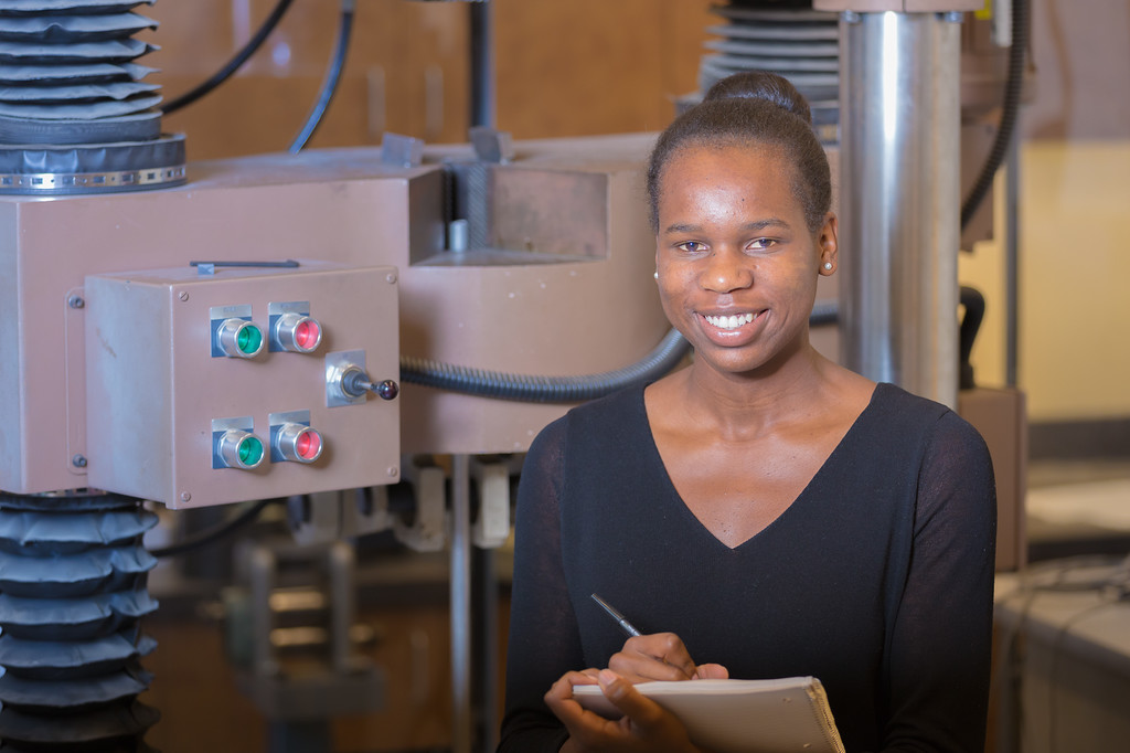 Student with notebook in engineering lab