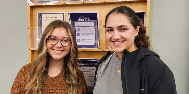 Students standing in front of a wall