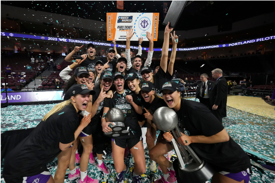 Women's basketball team celebrating 2023 West Coast Conference championship win