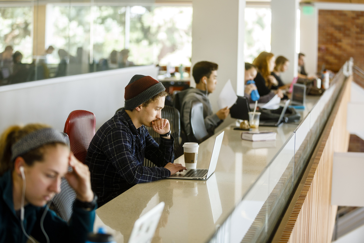 Students Sitting Along Balcony Bar