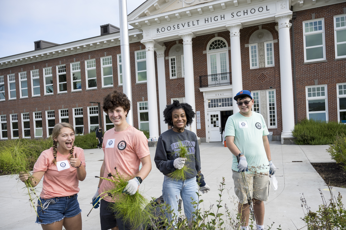 a group of students volunteering at Roosevelt High School during the Plunge. Standing outside.