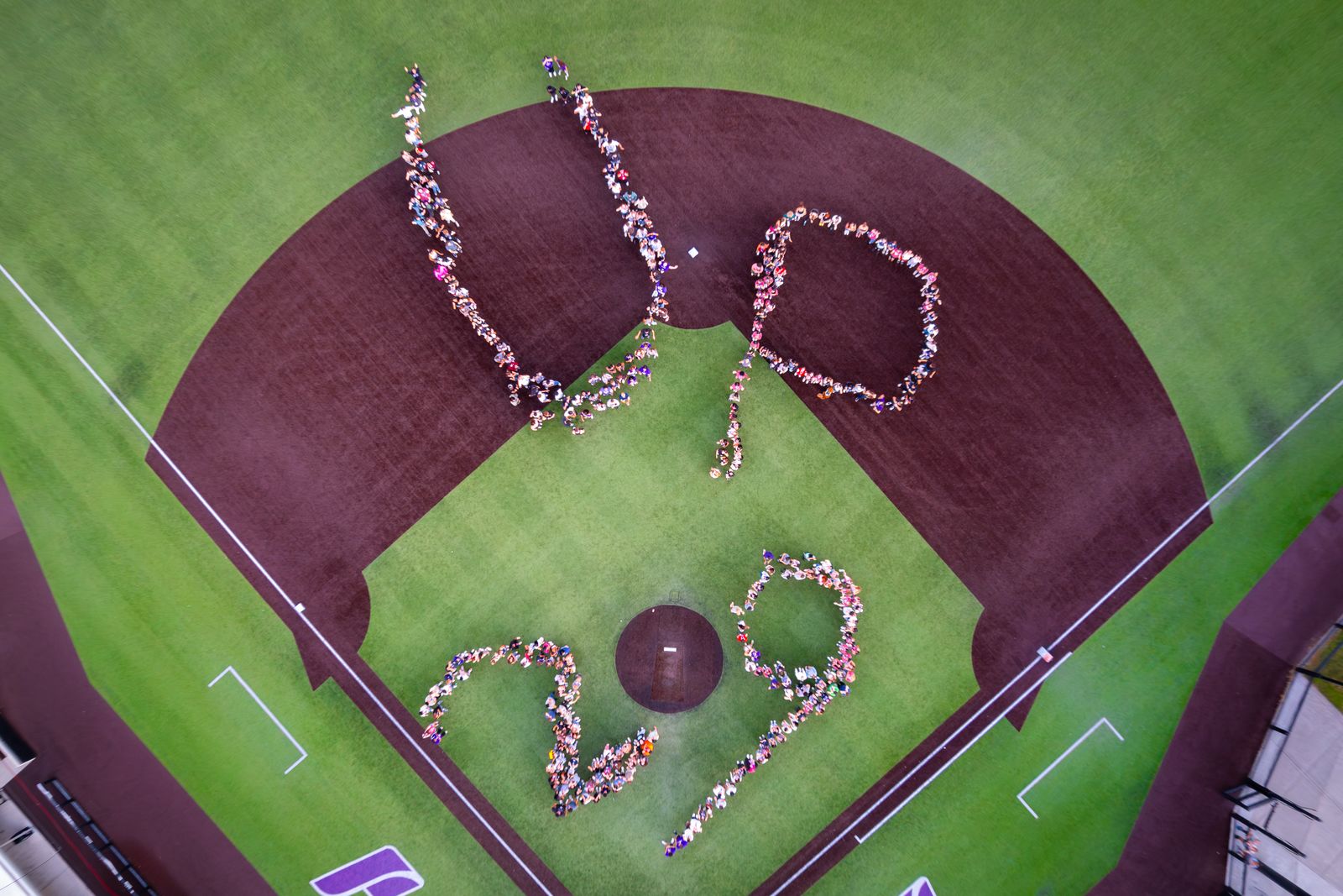 Aerial view of students on baseball diamond forming the words 'UP 29'
