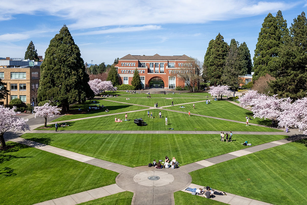 aerial view of the University of Portland academic quad ringed by cherry blossom trees and Franz Hall in the back background