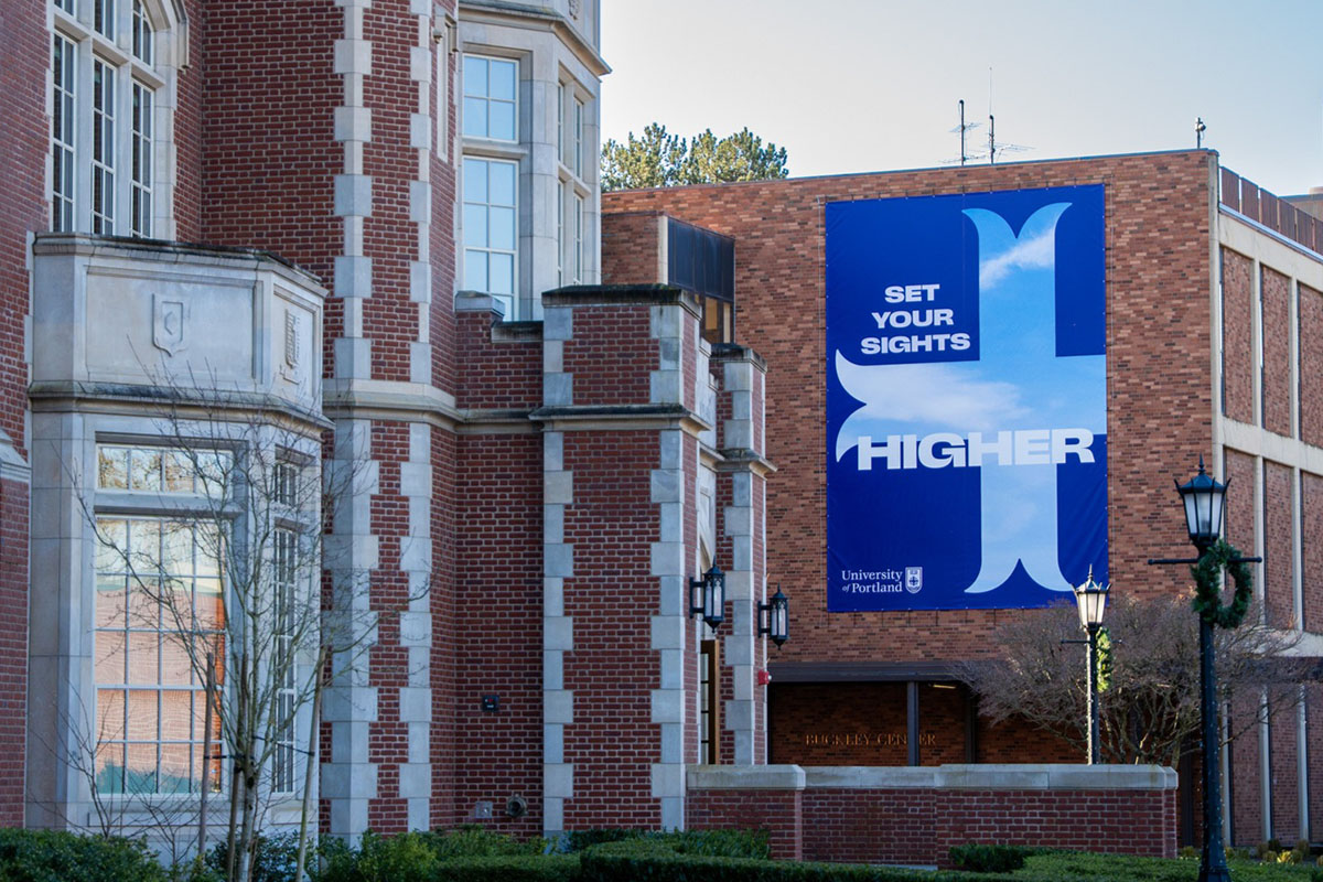 large banner that says 'set your sights higher' hangs on the wall of Buckley 