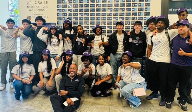 Dr Kelly poses with graduating high school students at De La Salle North Catholic
