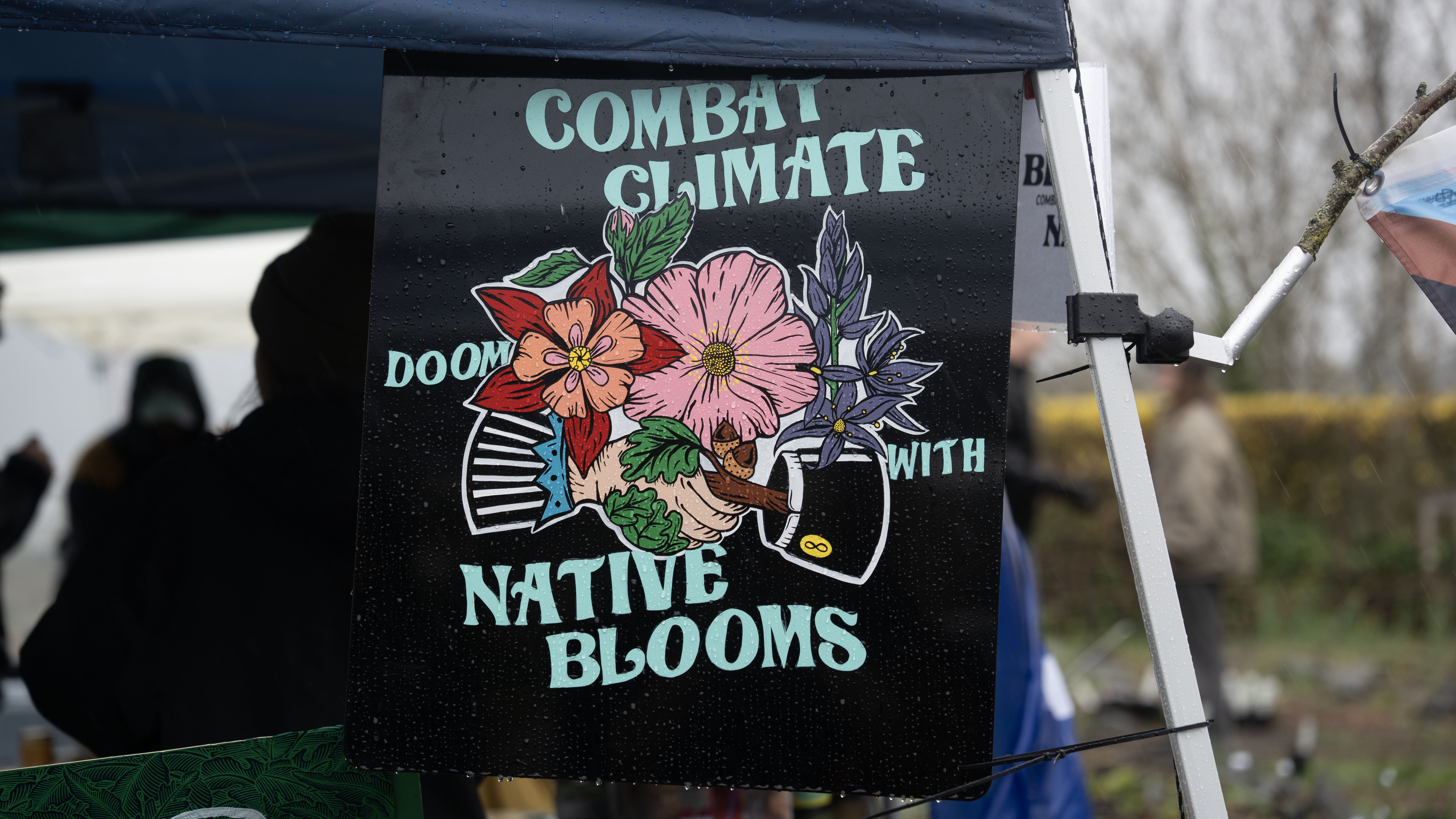 A sign at the SLUG garden encouraging people to plant native species.